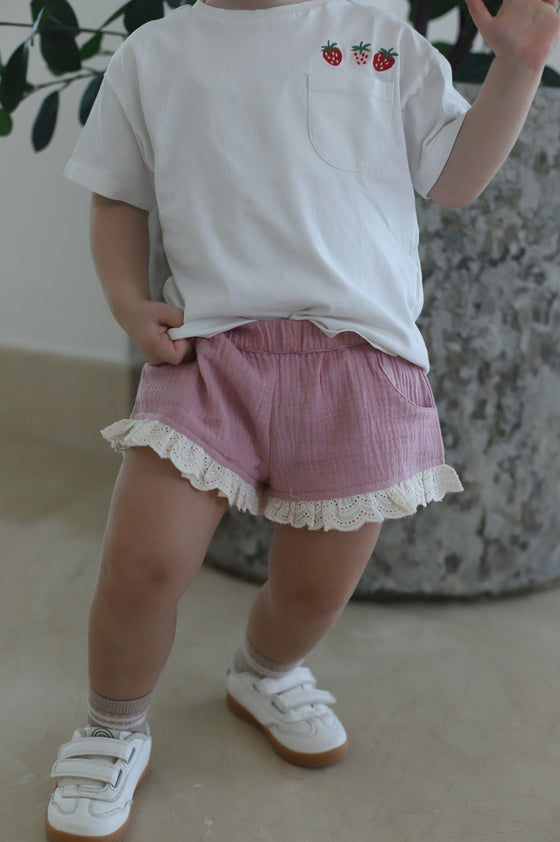 GINGI Girl Short Dust Pink Gabriella - Baby Girl Playing in Pink Muslin Cotton Shorts with Broderie Anglaise Lace