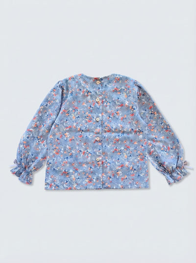 GINGI Samira Blouse Blue - Flat Lay Back View - Wooden Button Closure on Dusty Blue Floral Cotton
